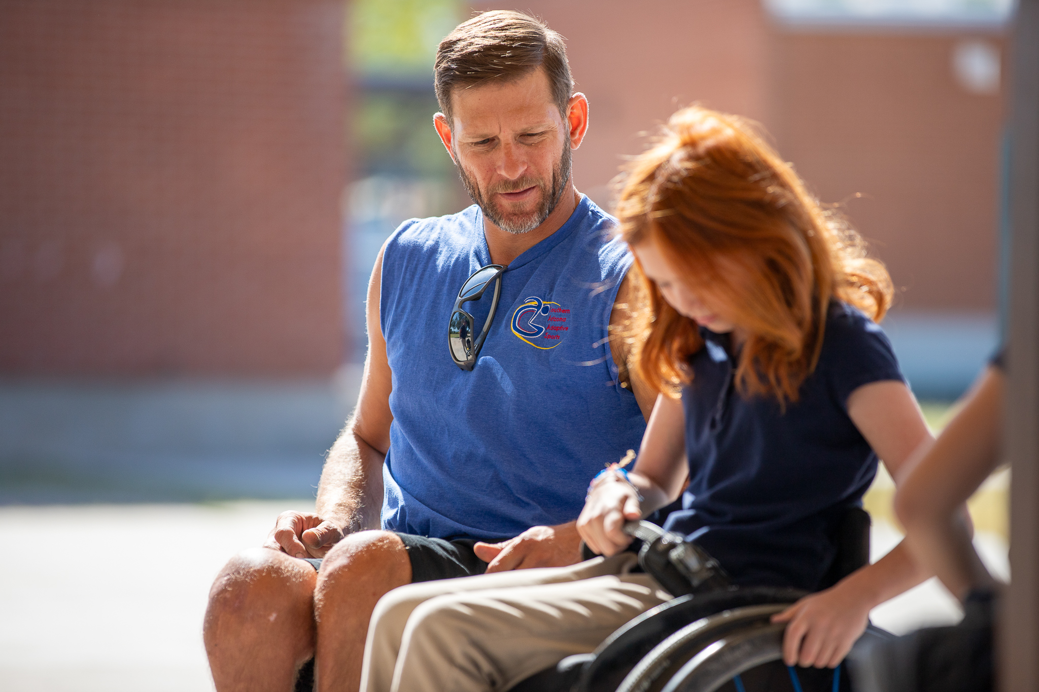 staff helping student on wheelchair