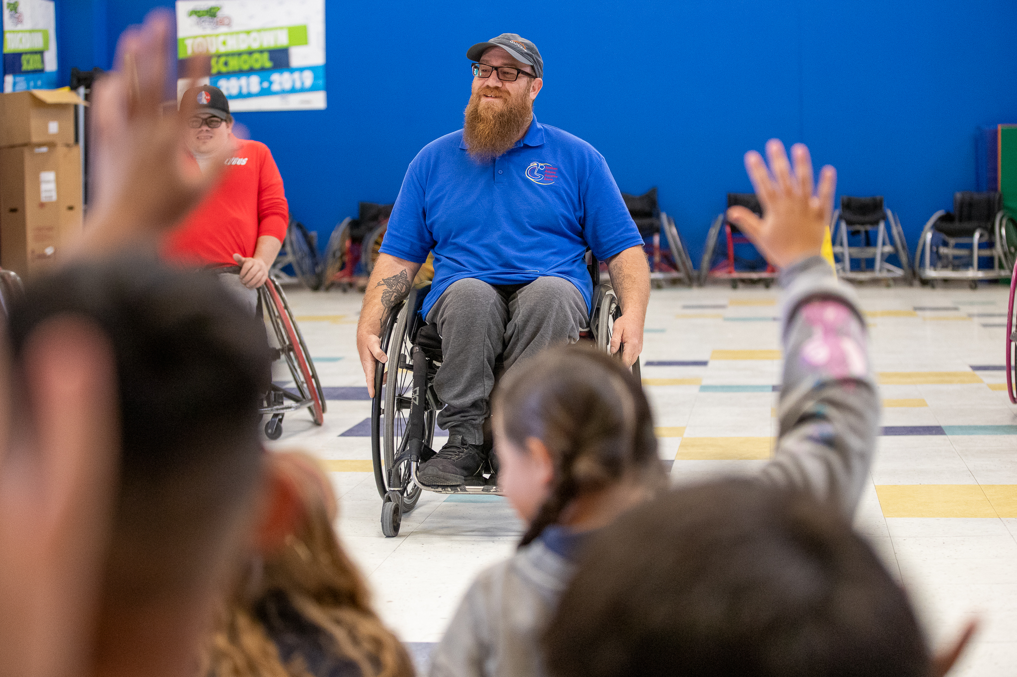 Man on wheelchair presenting in front of students