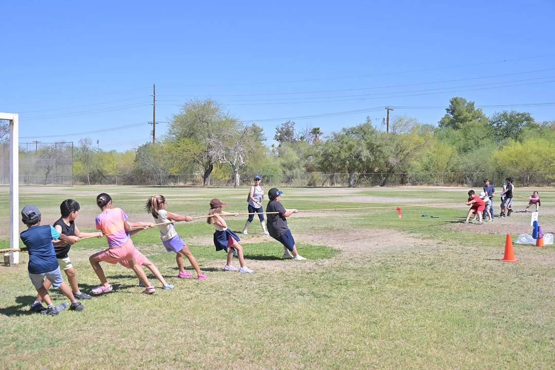 Students play tug of war on the field