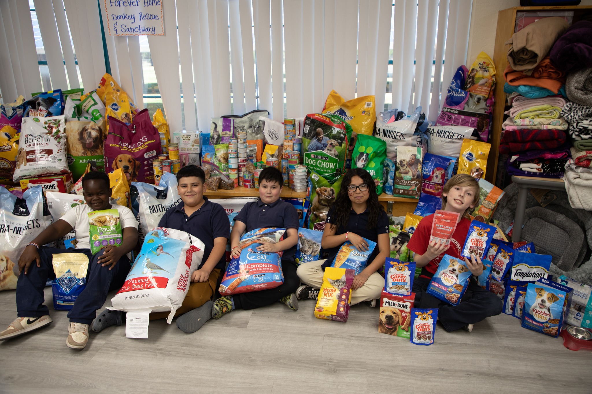 Robison students pose with the bags of pet food they're donating